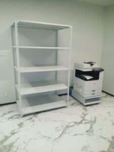 Empty, multi-shelf slotted angle racking unit, typical for warehouse or garage storage.