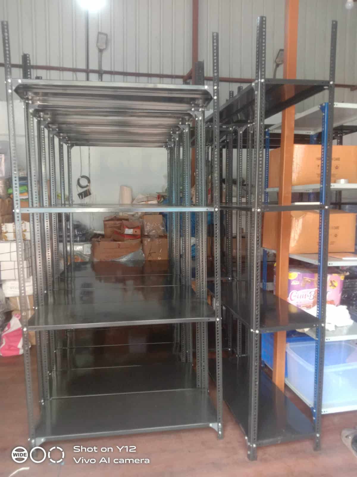 Custom slotted angle rack with 4 shelves installed at Roott Square Pune – boxes stored on shelves